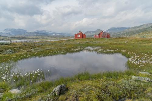 Red houses along Rallarvegen from Norway Hardangervidda Rallarvegen